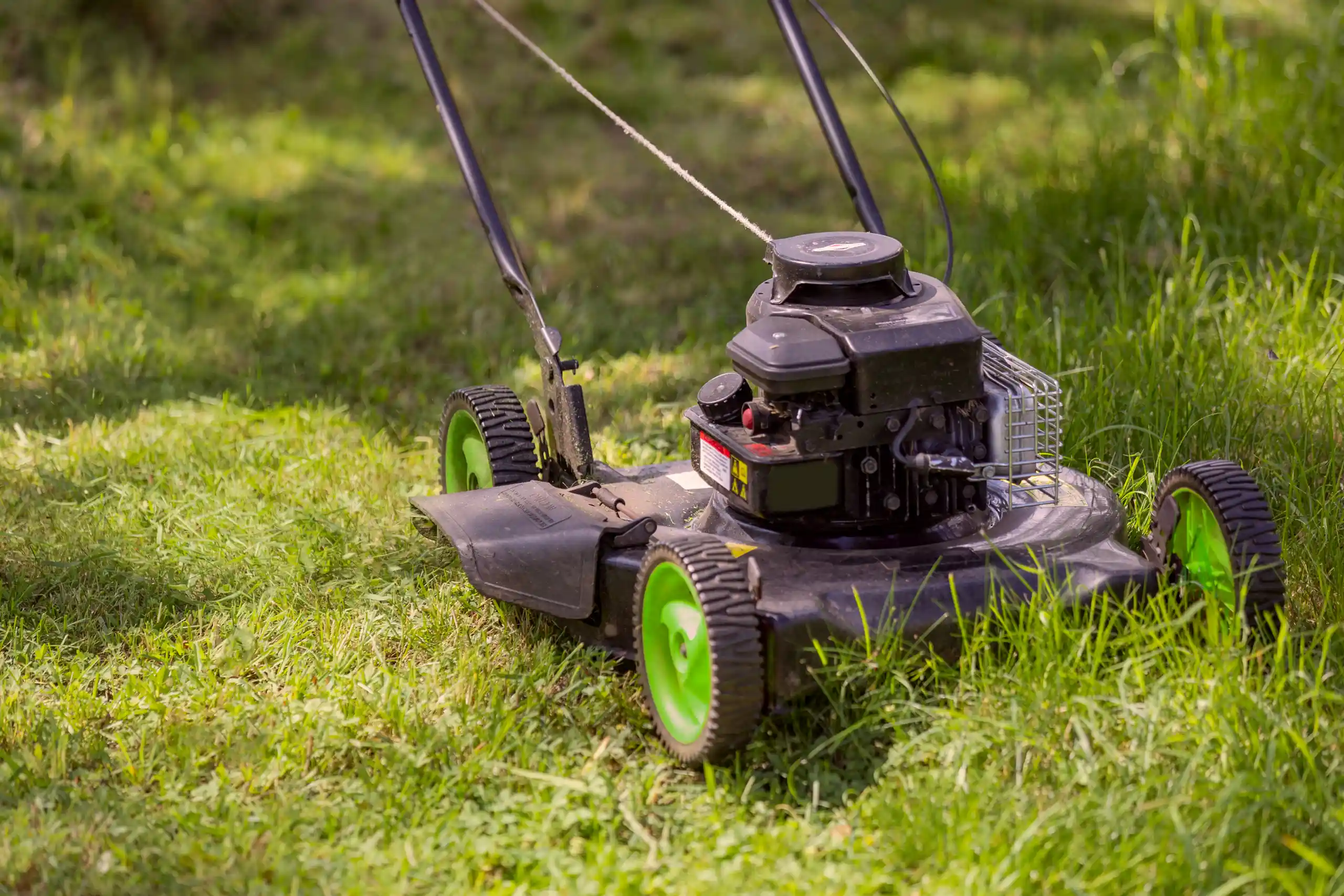 a closeup shot of a lawnmower on grass