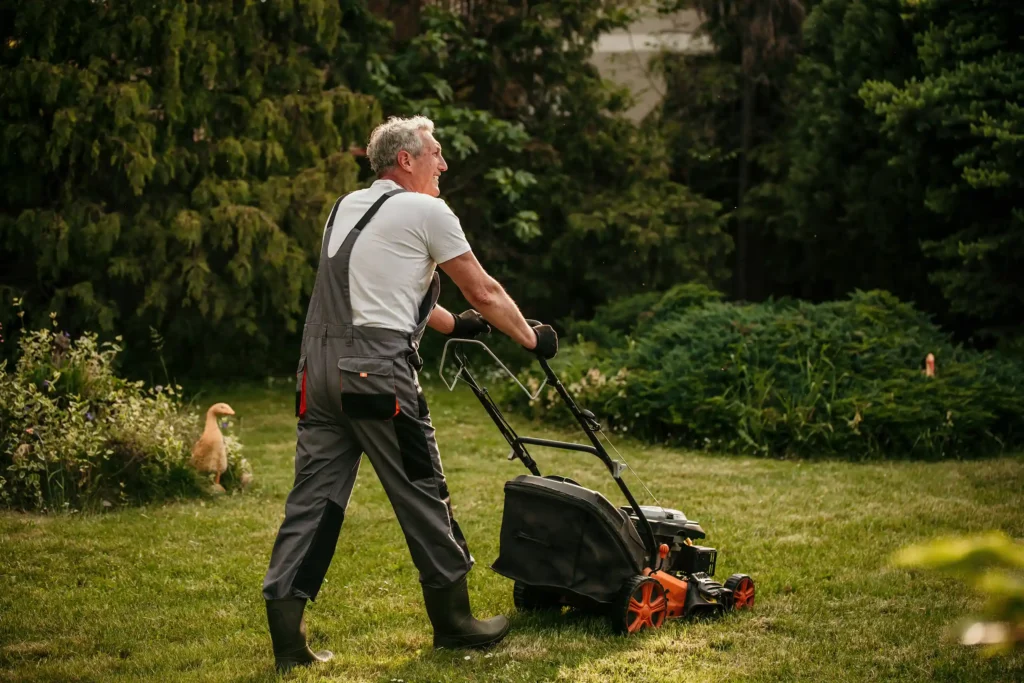 a man using a lawnmower